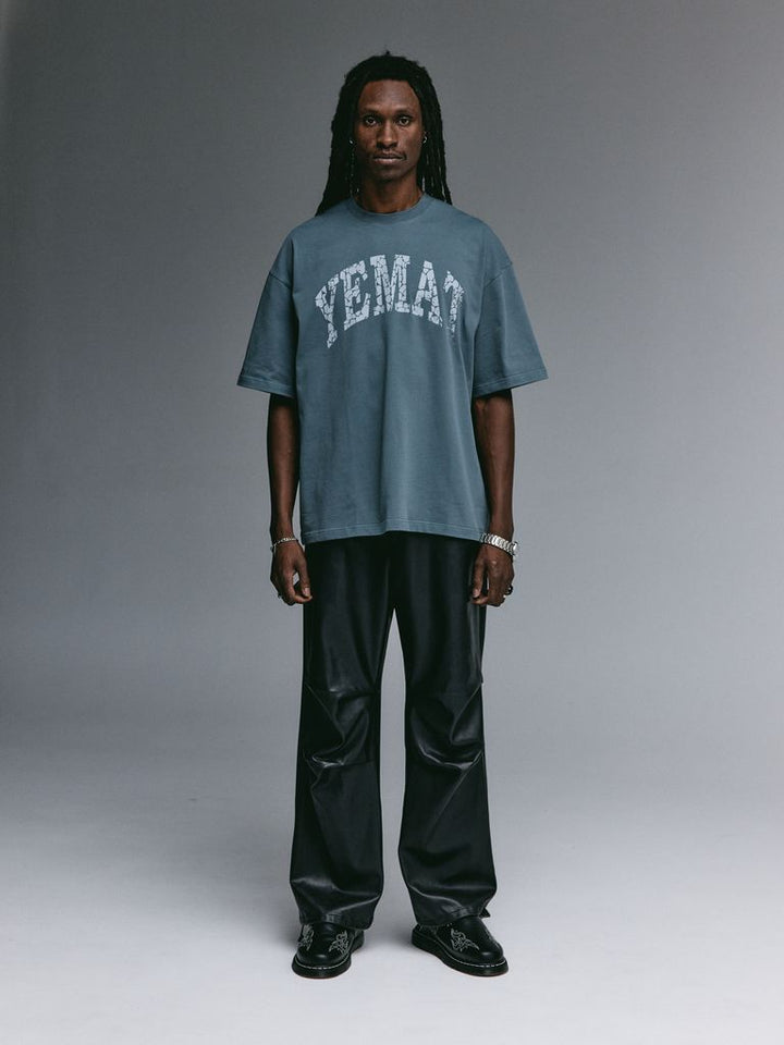 YEMAT Fracture Tee in deep teal worn by Dante, back view, oversized dropped-shoulder 240 GSM organic cotton tee