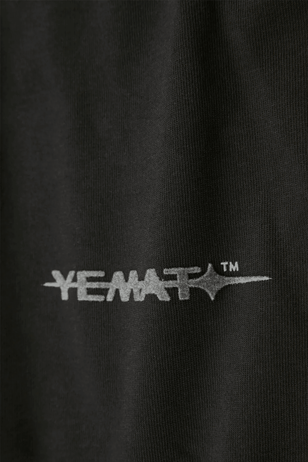 YEMAT Velvet Tee Black velvet logo macro showing raised pile texture, 240 GSM organic cotton