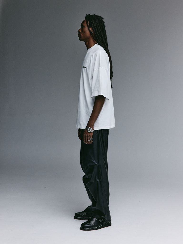 Dante wearing the YEMAT Velvet Tee White