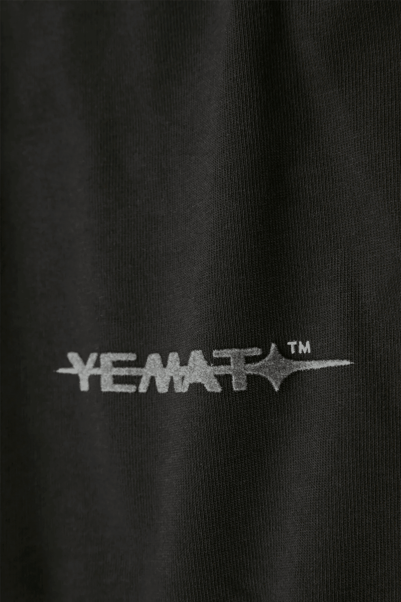 YEMAT Velvet Tee Black velvet logo macro showing raised pile texture, 240 GSM organic cotton