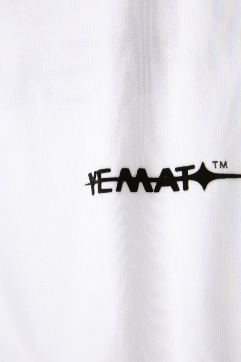 YEMAT Velvet Tee White macro detail of the raised velvet logo and cotton texture
